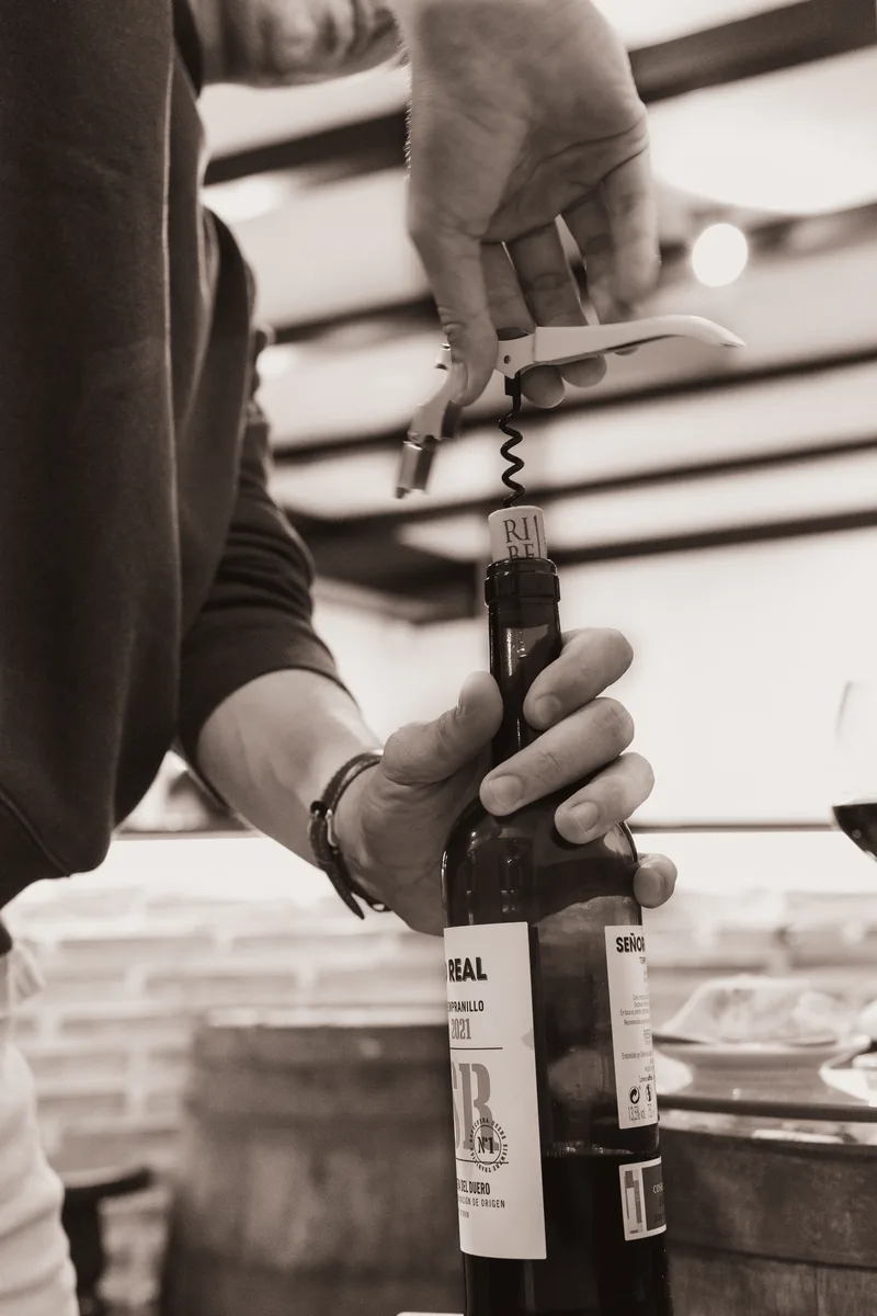 Opening a bottle at Taberna el Corcho